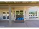 Covered back patio with exterior storage, french doors, and windows overlooking the pool area at 2818 N Yucca St, Chandler, AZ 85224