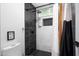 Modern bathroom featuring shower with black and white marble tile and rainfall shower head at 2818 N Yucca St, Chandler, AZ 85224