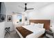 Bright bedroom with white linens, modern ceiling fan, and window with natural light at 2818 N Yucca St, Chandler, AZ 85224