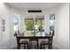 Bright dining area features a dark wood table and views of the lush backyard at 2818 N Yucca St, Chandler, AZ 85224