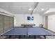 Finished garage featuring ping pong and pool tables, with a TV mounted to the wall at 2818 N Yucca St, Chandler, AZ 85224