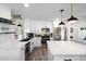 Modern kitchen with white cabinets, stainless steel appliances, and quartz countertops at 2818 N Yucca St, Chandler, AZ 85224