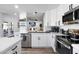 Bright kitchen with white cabinets, subway tile backsplash, and stainless steel appliances at 2818 N Yucca St, Chandler, AZ 85224