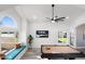 Open living space featuring a pool table, window seat, large windows, and a ceiling fan at 2818 N Yucca St, Chandler, AZ 85224