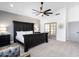 Large main bedroom with a dark wood bed frame, ceiling fan, and large window at 2818 N Yucca St, Chandler, AZ 85224