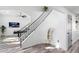 Entryway staircase with modern black railing and a view into the living area at 2818 N Yucca St, Chandler, AZ 85224