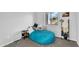 Bedroom with beanbag chair, side table, and large window providing natural light at 28204 N Royce Rd, Queen Creek, AZ 85144