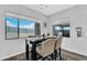 Sunlit dining area with a high table set, upholstered chairs, and a view to the fenced outdoor space at 28204 N Royce Rd, Queen Creek, AZ 85144