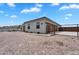 This desert home features a large two-car garage, desert landscaping, and an expansive driveway at 28204 N Royce Rd, Queen Creek, AZ 85144