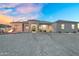 Beautiful exterior of this home featuring desert landscaping, a fire pit and charming front porch at 28204 N Royce Rd, Queen Creek, AZ 85144