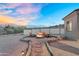 Outdoor fire pit area with comfortable seating, desert landscaping, and perimeter fencing at 28204 N Royce Rd, Queen Creek, AZ 85144