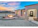 A cozy fire pit area near the entrance with desert views and a welcoming front porch at 28204 N Royce Rd, Queen Creek, AZ 85144