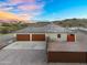 This desert home features a large two-car garage and an expansive driveway at 28204 N Royce Rd, Queen Creek, AZ 85144
