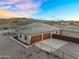 This desert home features a large two-car garage, large driveway, and desert landscaping at 28204 N Royce Rd, Queen Creek, AZ 85144