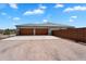 This desert home features a large two-car garage and an expansive driveway at 28204 N Royce Rd, Queen Creek, AZ 85144