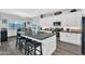 Bright kitchen with a center island, bar stool seating, and sleek stainless steel appliances at 28204 N Royce Rd, Queen Creek, AZ 85144