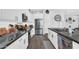 A well-equipped kitchen features stainless steel appliances and white cabinets, providing a modern, sleek design at 28204 N Royce Rd, Queen Creek, AZ 85144