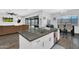 A well-lit kitchen island overlooks a comfortable living area with a modern design and open layout at 28204 N Royce Rd, Queen Creek, AZ 85144