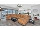 Spacious living room flowing into the kitchen with a large sectional and modern finishes at 28204 N Royce Rd, Queen Creek, AZ 85144