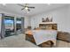 Comfortable primary bedroom with a sliding glass door, ceiling fan, and neutral decor at 28204 N Royce Rd, Queen Creek, AZ 85144