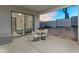 Covered patio with bedroom view, dining set, and desert landscape with cactus at 28204 N Royce Rd, Queen Creek, AZ 85144