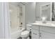 Well-lit bathroom with white cabinetry, modern fixtures, and shower-tub combo, perfect for relaxation at 2900 E Spring Wheat Ln, Gilbert, AZ 85296