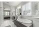 Bright bathroom with modern tub, double vanity and fixtures with view to main bedroom at 2900 E Spring Wheat Ln, Gilbert, AZ 85296