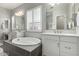 Bright bathroom with modern tub and fixtures and double vanity, complemented by natural light at 2900 E Spring Wheat Ln, Gilbert, AZ 85296