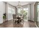 Bright dining room features a round table, stylish chandelier, and a sliding glass door to the yard at 2900 E Spring Wheat Ln, Gilbert, AZ 85296