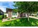 Attractive home with brick accents, lush green lawn, and mature trees for shade at 2900 E Spring Wheat Ln, Gilbert, AZ 85296