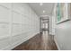 Modern hallway with decorative wall paneling, tile flooring, and recessed lighting at 2900 E Spring Wheat Ln, Gilbert, AZ 85296