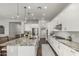 Bright kitchen features white cabinets, stainless steel appliances, granite countertops and a kitchen island at 2900 E Spring Wheat Ln, Gilbert, AZ 85296