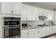 Contemporary kitchen showcases granite counters, stainless steel appliances, and sleek white cabinets at 2900 E Spring Wheat Ln, Gilbert, AZ 85296