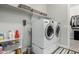 Functional laundry room featuring a modern washer and dryer with convenient shelving at 2900 E Spring Wheat Ln, Gilbert, AZ 85296