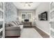 Comfortable living room with blue accent wall, neutral sofa, and modern decor, plus work space at 2900 E Spring Wheat Ln, Gilbert, AZ 85296