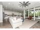 Spacious living room featuring a large sectional sofa, and large windows offering ample natural light at 2900 E Spring Wheat Ln, Gilbert, AZ 85296