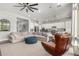 Comfortable living room with a large sectional sofa and a stylish blue ottoman on a light rug at 2900 E Spring Wheat Ln, Gilbert, AZ 85296