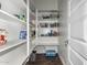 Well-organized pantry with white shelving and a variety of food items in baskets and containers at 2900 E Spring Wheat Ln, Gilbert, AZ 85296