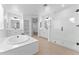 Bright primary bathroom with tub, shower, sinks, tile flooring, and ample room at 3557 S Halsted Ct, Chandler, AZ 85286