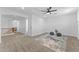 Bright bedroom features carpeted flooring, a ceiling fan, and a view of the hall from the doorway at 3557 S Halsted Ct, Chandler, AZ 85286