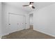 Bedroom boasts a ceiling fan, carpet and a well sized closet at 3557 S Halsted Ct, Chandler, AZ 85286