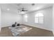 Spacious bedroom with plush carpeting, arched windows with shutters, and stylish ceiling fan at 3557 S Halsted Ct, Chandler, AZ 85286