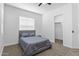 Comfortable bedroom featuring a ceiling fan, soft carpet, and a convenient walk-in closet at 3557 S Halsted Ct, Chandler, AZ 85286