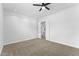 Neutral carpeted bedroom featuring a ceiling fan and open doorway to additional rooms at 3557 S Halsted Ct, Chandler, AZ 85286