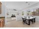 Bright dining area features a stylish chandelier, large windows, and a seamless transition to the cozy living space at 3557 S Halsted Ct, Chandler, AZ 85286