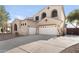 Inviting home exterior with neutral stucco, arched windows, three-car garage, and expansive driveway at 3557 S Halsted Ct, Chandler, AZ 85286