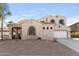 Inviting home exterior with neutral stucco, arched windows, tile roof, two-car garage and rock landscaping at 3557 S Halsted Ct, Chandler, AZ 85286