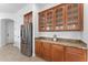 Kitchen featuring a stainless steel refrigerator, granite countertops, and wooden cabinets for a stylish cooking experience at 3557 S Halsted Ct, Chandler, AZ 85286