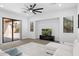 Bright living area boasting a ceiling fan, white sectional, entertainment center, and sliding glass doors at 3557 S Halsted Ct, Chandler, AZ 85286