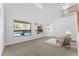 Bright living room with high ceilings, gray chairs, neutral carpet and a view of the swimming pool at 3557 S Halsted Ct, Chandler, AZ 85286